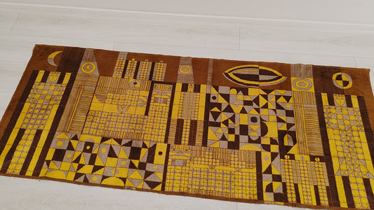Video footage of the vintage tapestry, panning over the soft surace of the textile, showing the warm 1960s colors and the typical mid-century design. Giant abstract-geometric cityscape that makes a commanding focal point in any room.