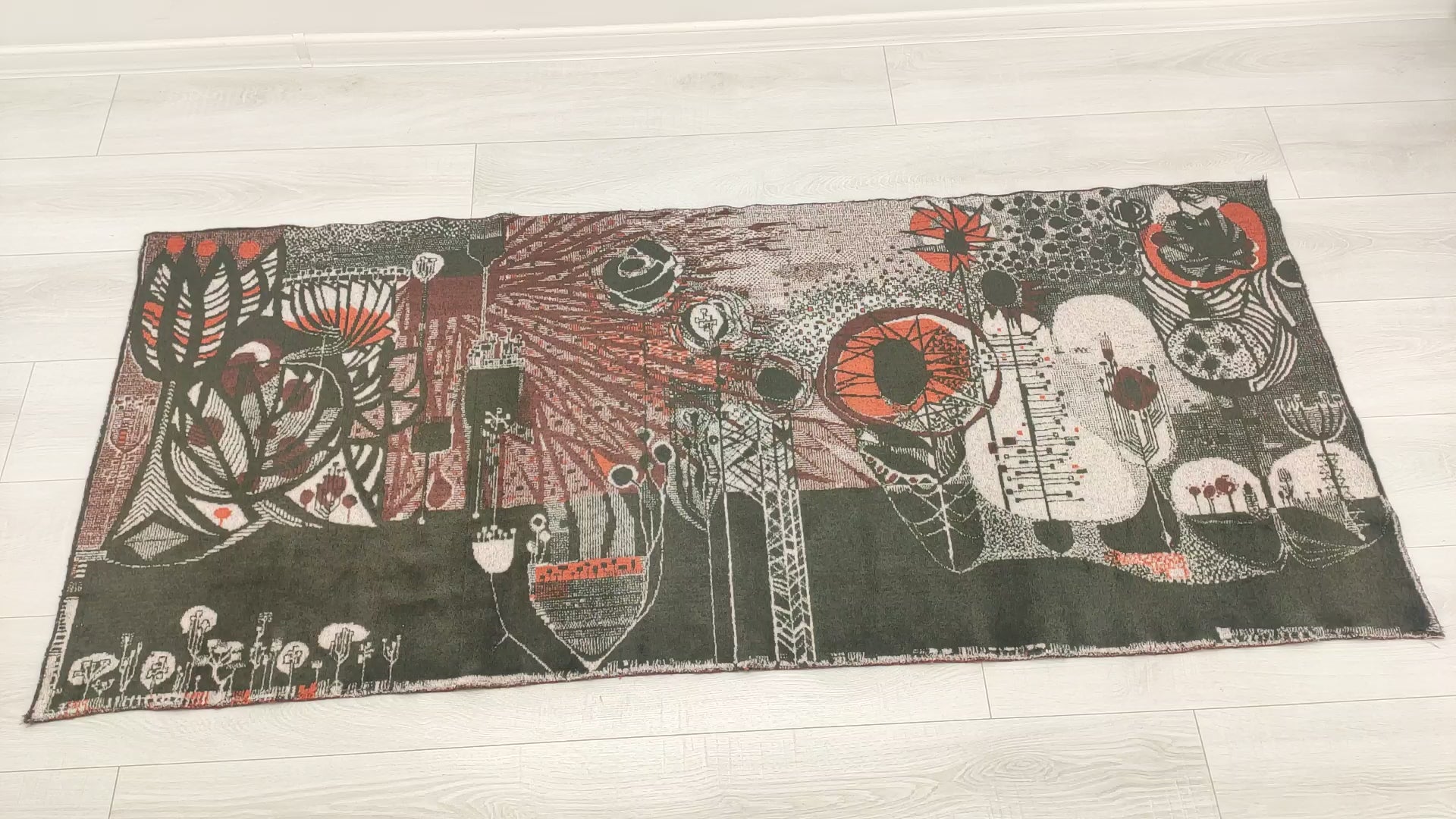 Video footage of an authentic 1960s mid century modern tapestry. A fascinating abstract, organic-brutalist design by award-winning Hungarian designer László Pécsi on a dark olive and grey background. Full view and macro shots demonstrating the outstanding mid-century design and high quality of this home decor staple.