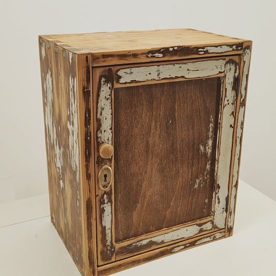 Video of a refurbished vintage solid pine wall cabinet with chippy white paint, showing the satin wax finish, the door opening and the removable shelf inside.