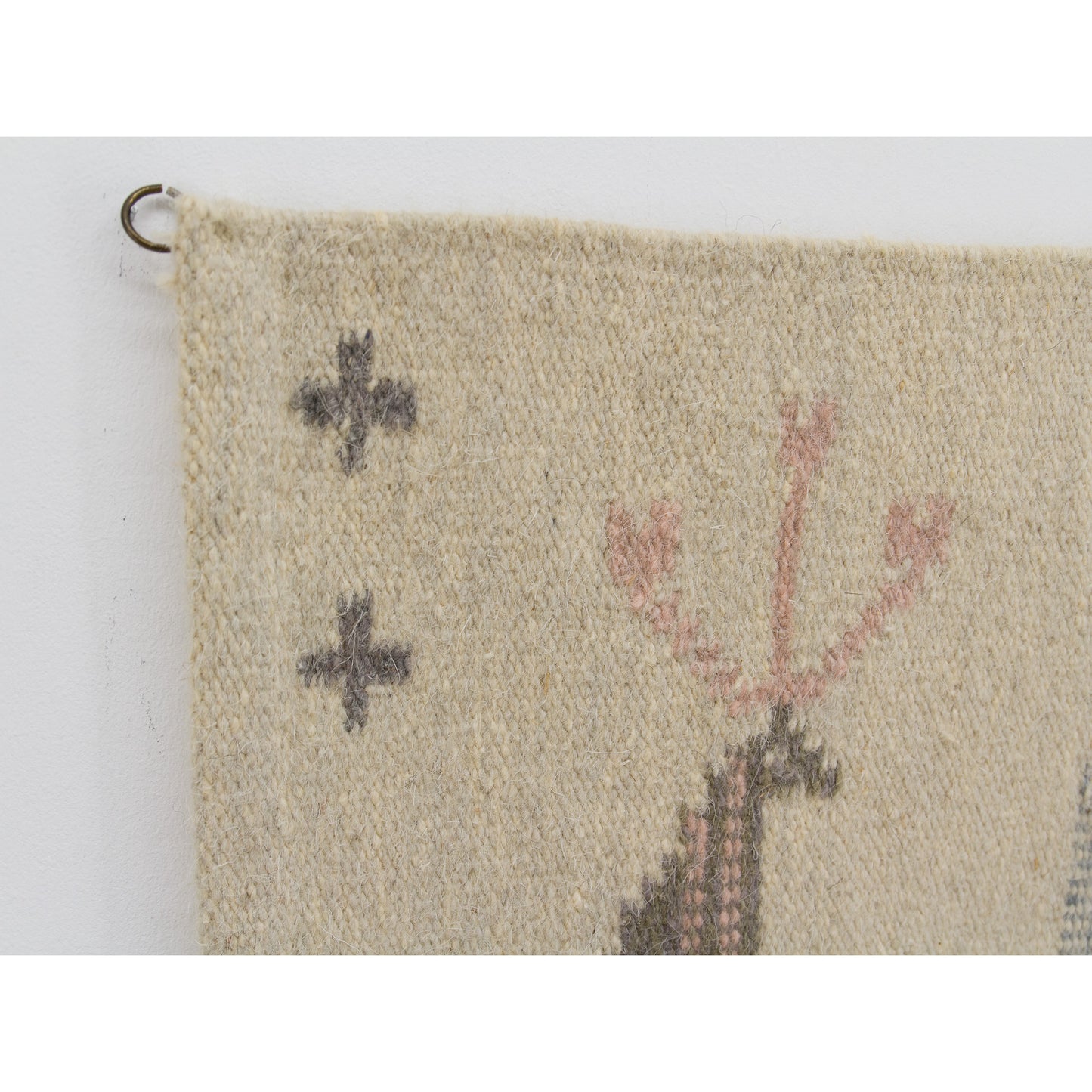 Upper corner turned backward to display a sturdy, perfectly sized original metal hanging ring sewn securely into the tapestry, making installation effortless.