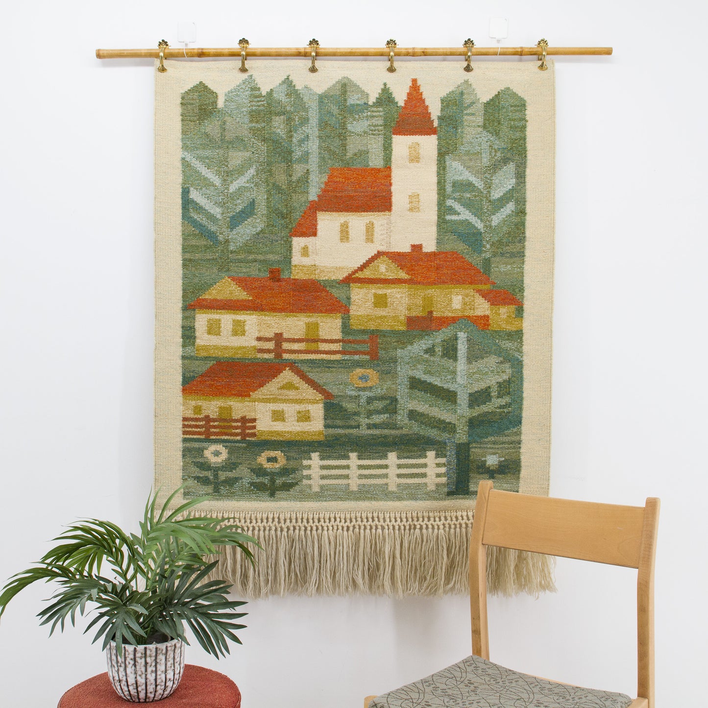 Close up of the warm cottagecore aesthetic wall art showing the beautiful flatweave rural scene displayed gracefully on a bamboo rod using curtain clips.
