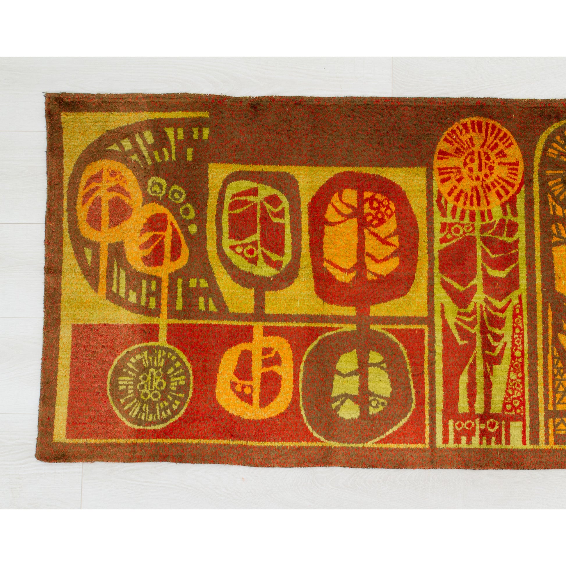 Left half of the vintage tapestry wall hanging, emphasizing the vibrant autumn retro hues of burnt orange, mustard yellow, and deep brown.
