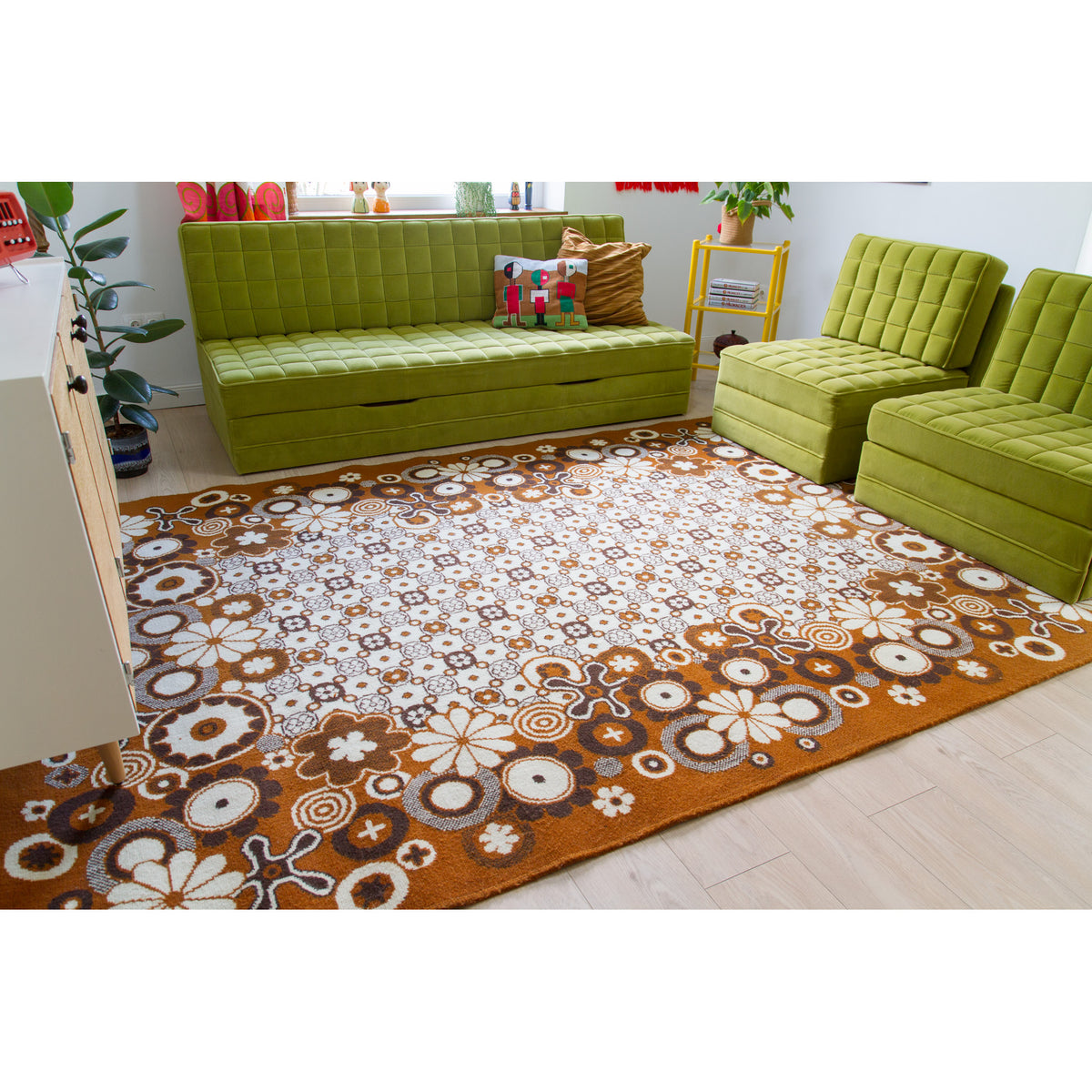 Large retro psychedelic floral rug in an authentic 70s style living room with lime green modular sofa