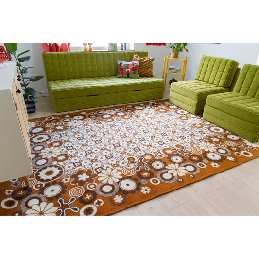 Large retro psychedelic floral rug in an authentic 70s style living room with lime green modular sofa
