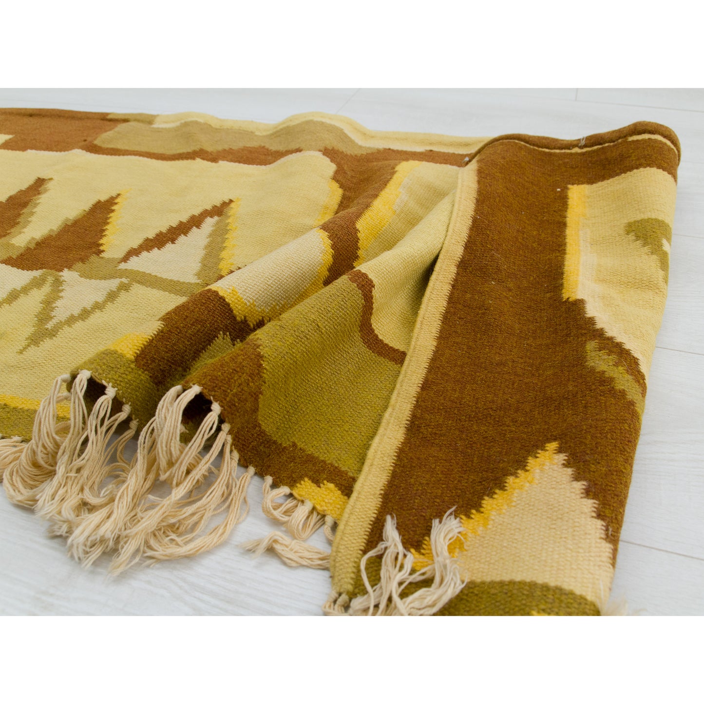 A corner is flipped up, showcasing the finely stitched borders on the shorter ends and confirming this quality Hungarian flatweave piece is double-sided.