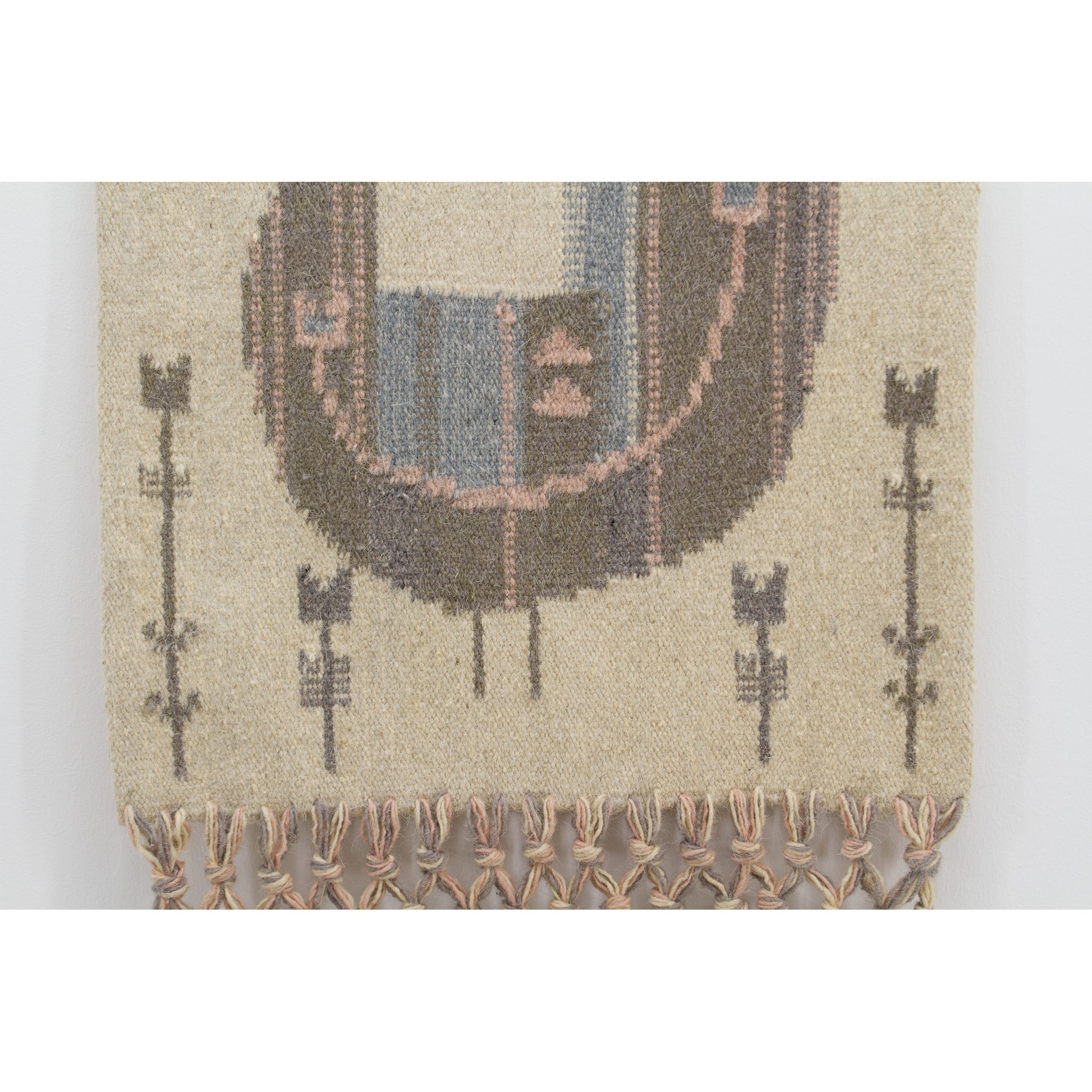 Lower view of the handwoven textile featuring lovely stylized floral folk-art motifs branching off below the abstract mid-century bird graphic.