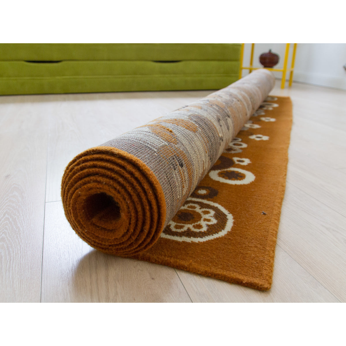 Rolled up 70s area rug showing the damage-free edges and compact size