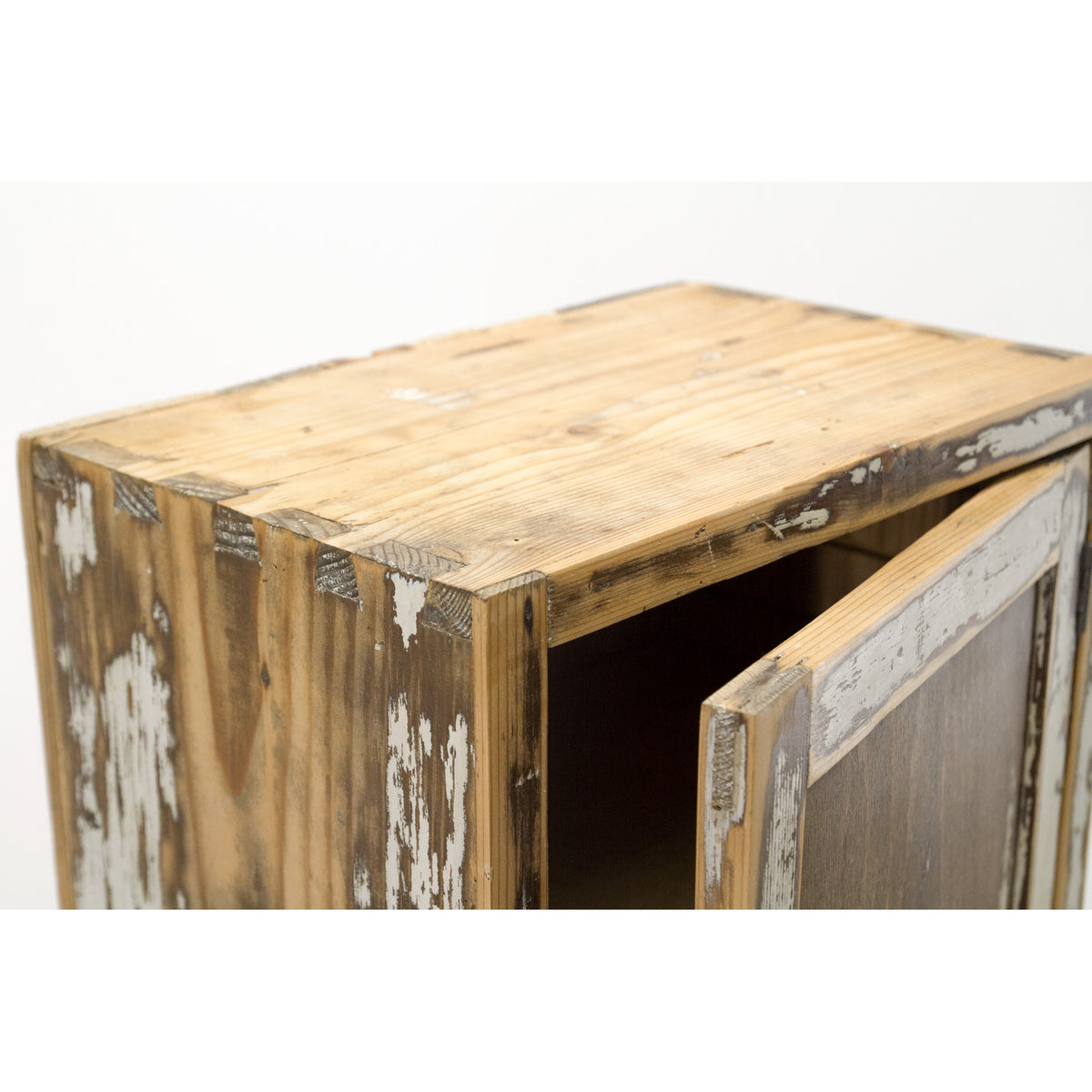 Small vintage medicine cabinet with soft satin finish, with antique patina of peeling white paint, showing a natural wood grain and an open door revealing a dark interior, set against a plain white background.