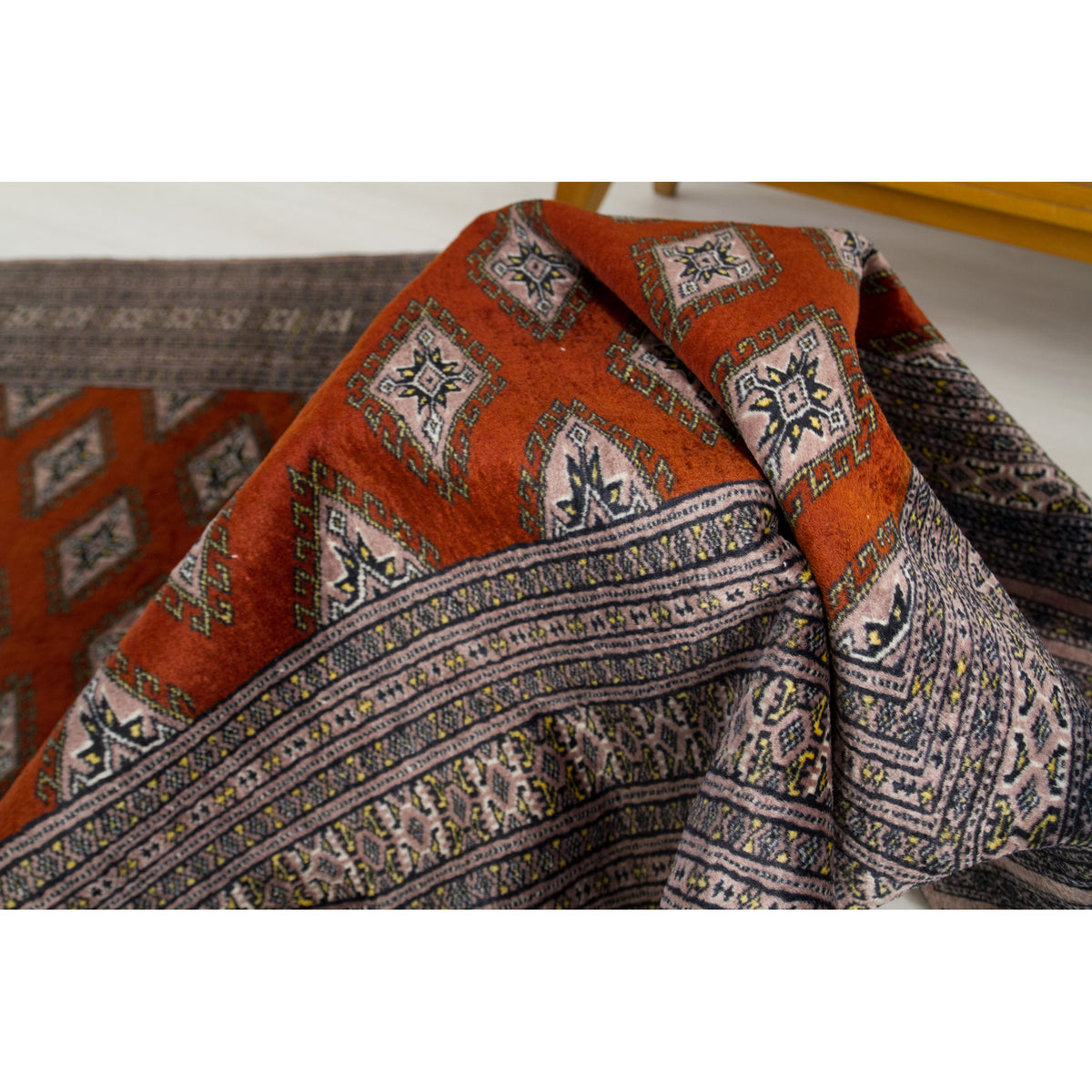 Draped vintage silk rug showing the soft sheen of the rust red pile and diamond guls