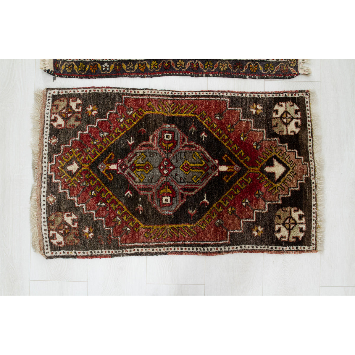 Small vintage brown Anatolian rug with a red and grey tribal diamond medallion and hooked motifs
