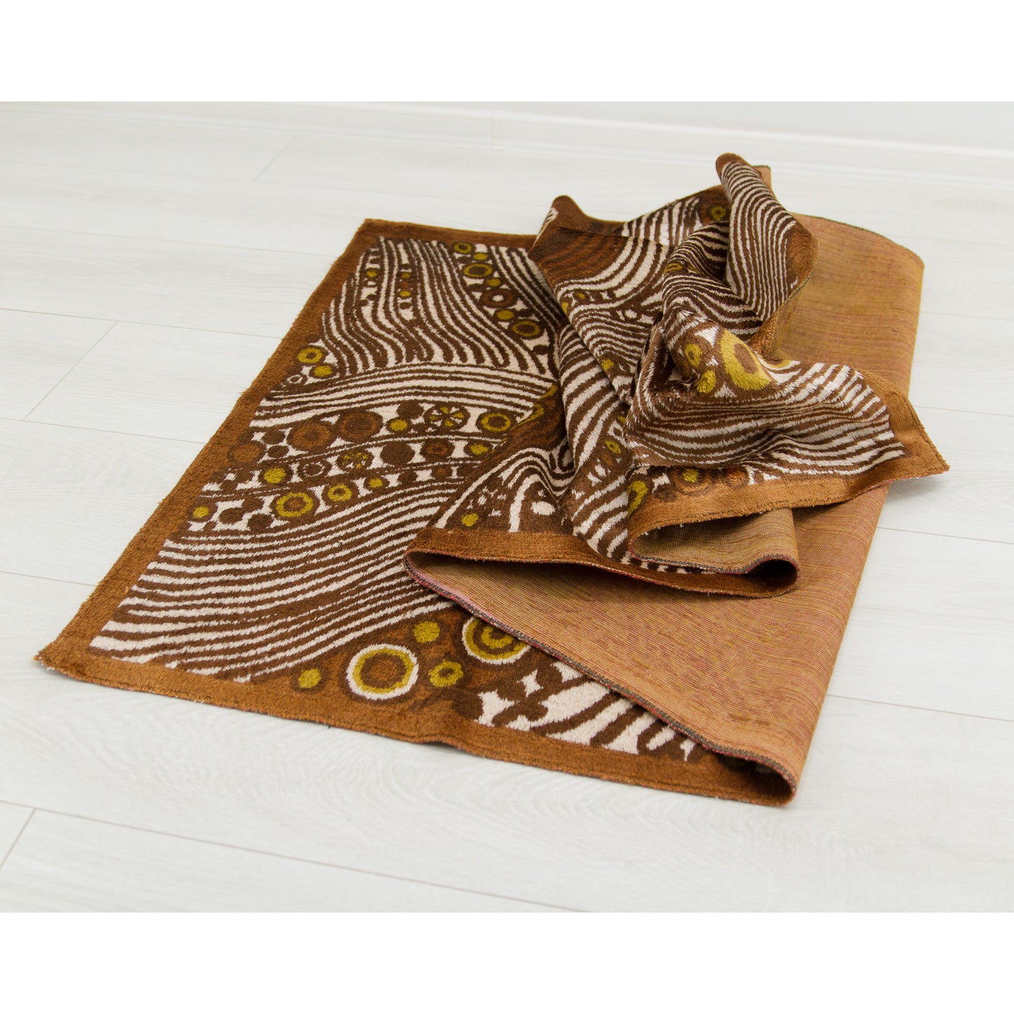 The tapestry gathered and softly draped along the floor to show off its phenomenal pliability. Despite being thick and durable, the soft material ripples like a massive luxurious throw.