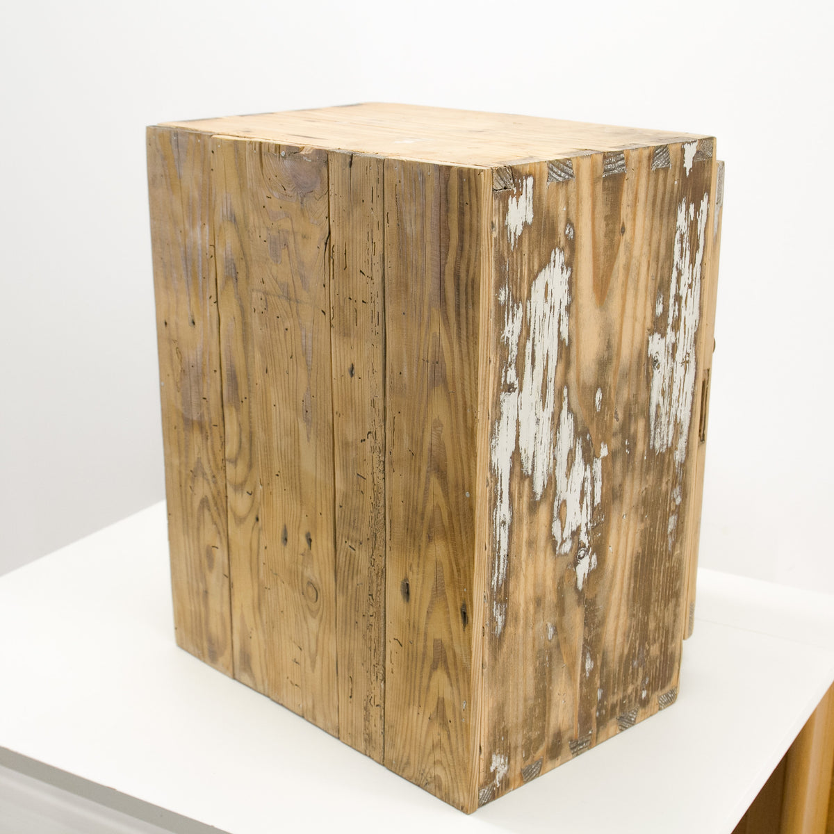 A rustic wooden wall cabinet with a refurbished, satin shine distressed finish, showing weathered brown wood planks and peeling white paint, set on a white surface against a white background.