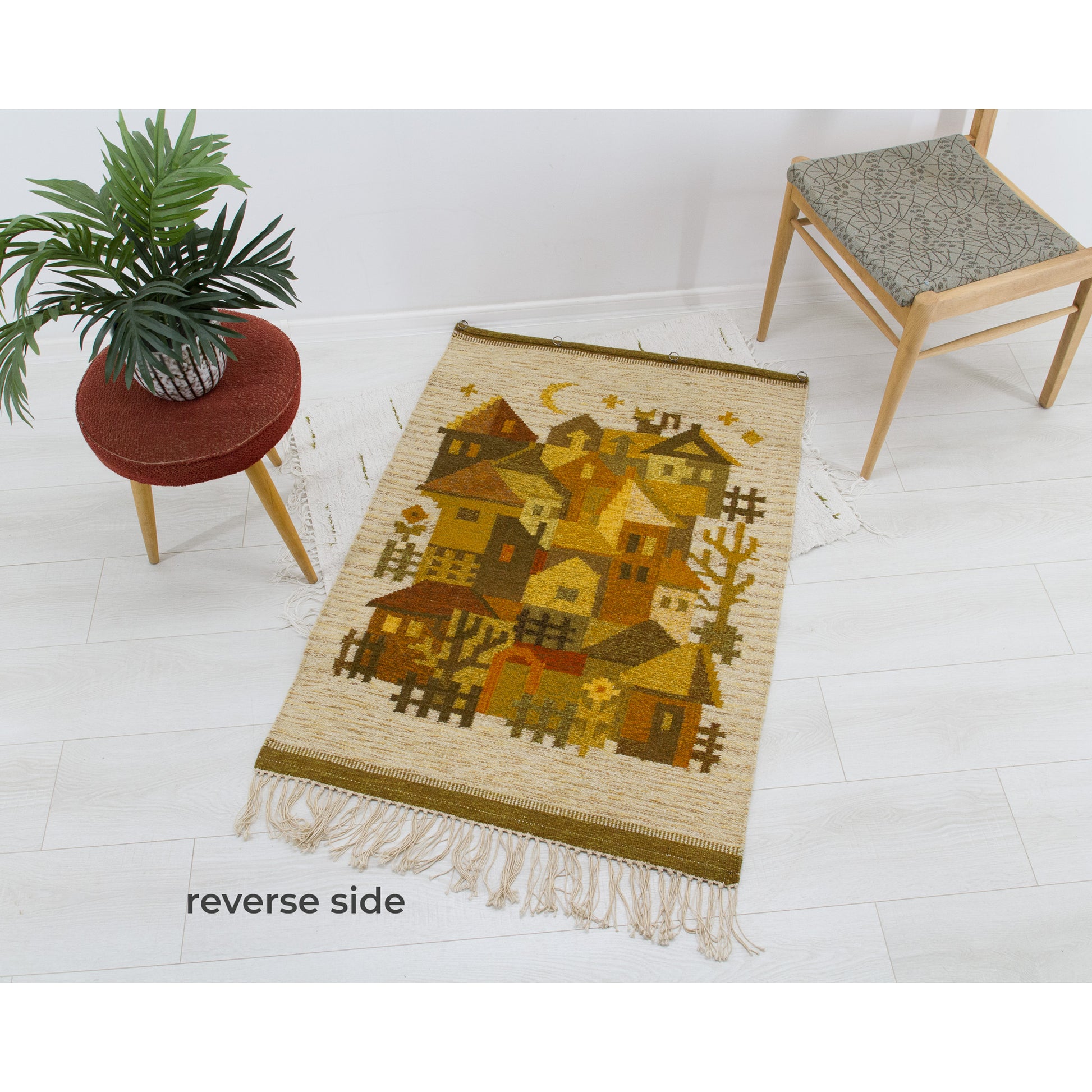 The heavy woven tapestry laid flat across a bright floor with its back side up, verifying excellent preservation with absolutely no odors, rips, or fading.