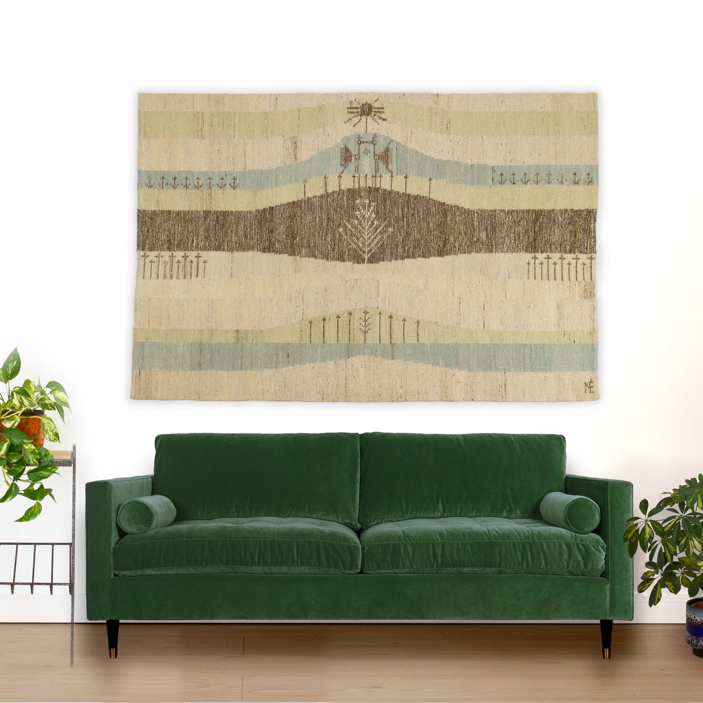 Majestic mid-century tapestry hanging above an emerald green sofa. At 80 inches wide, this oversized Scandinavian textile art creates a breathtaking focal point in a mid-century modern living room.