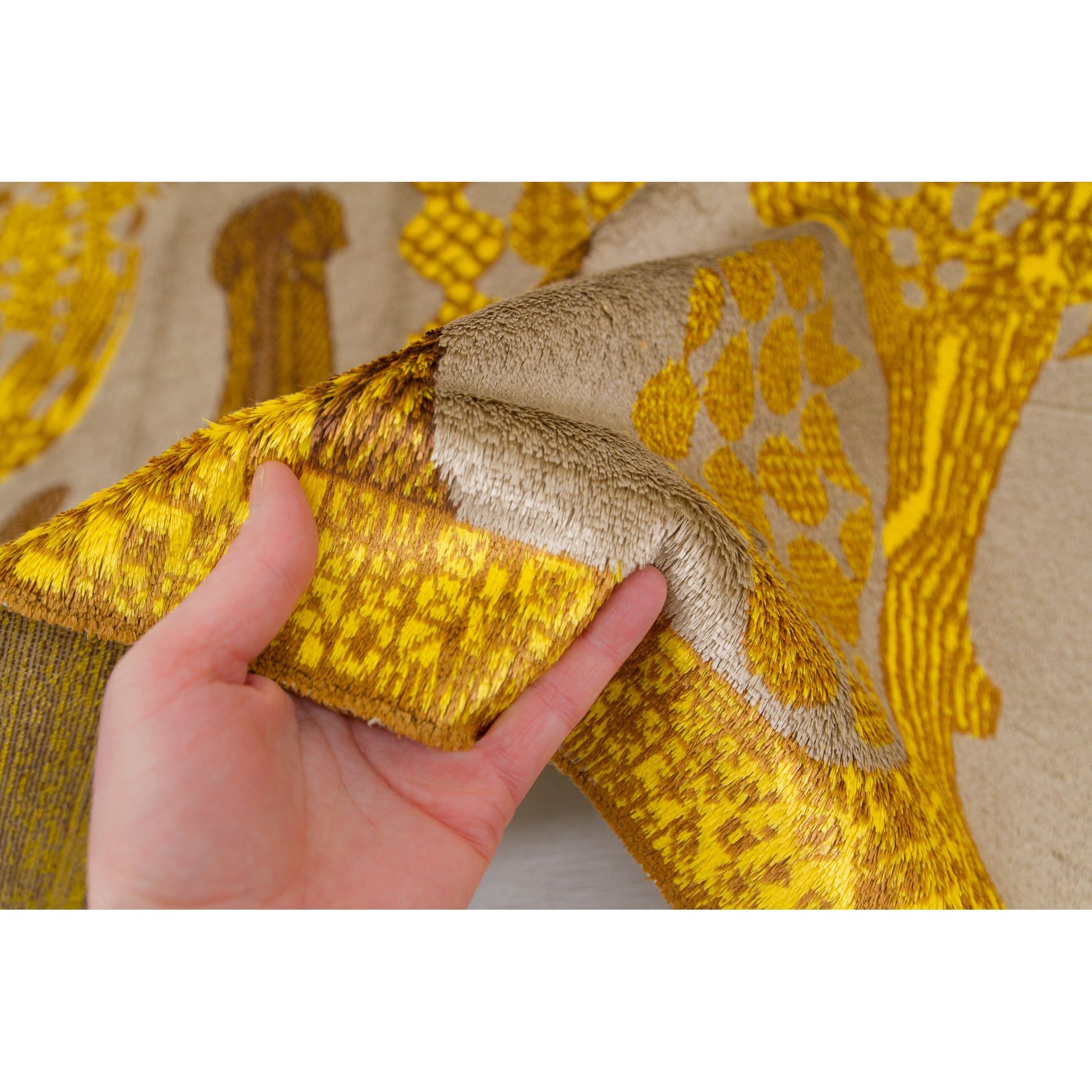 Holding the mid century style rug directly into the light to exhibit the gentle, highly sophisticated velvet sheen characteristic of premium 60s industrial textiles.