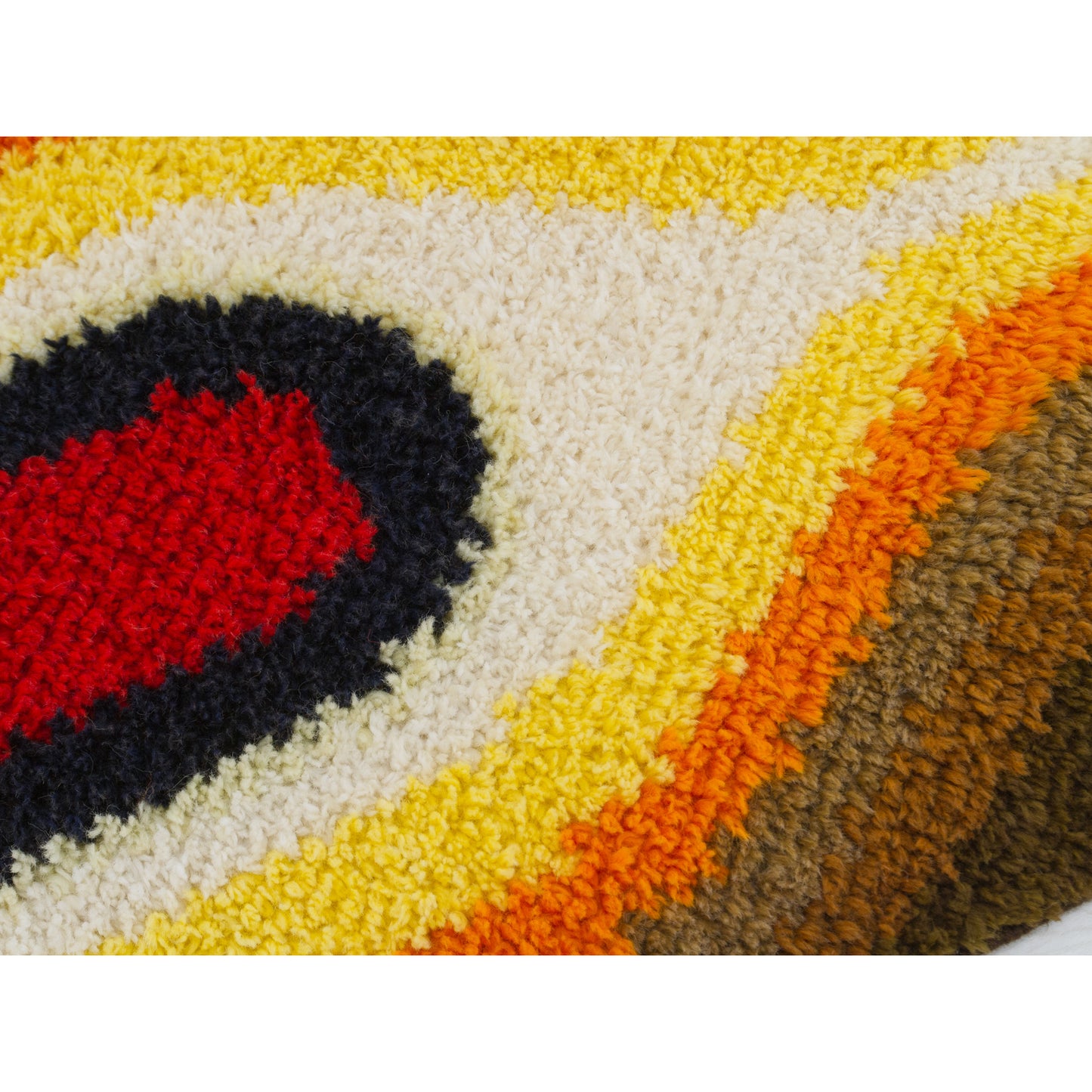 Macro photograph capturing the plush, thick yarns of the tactile abstract op-art wall art piece.