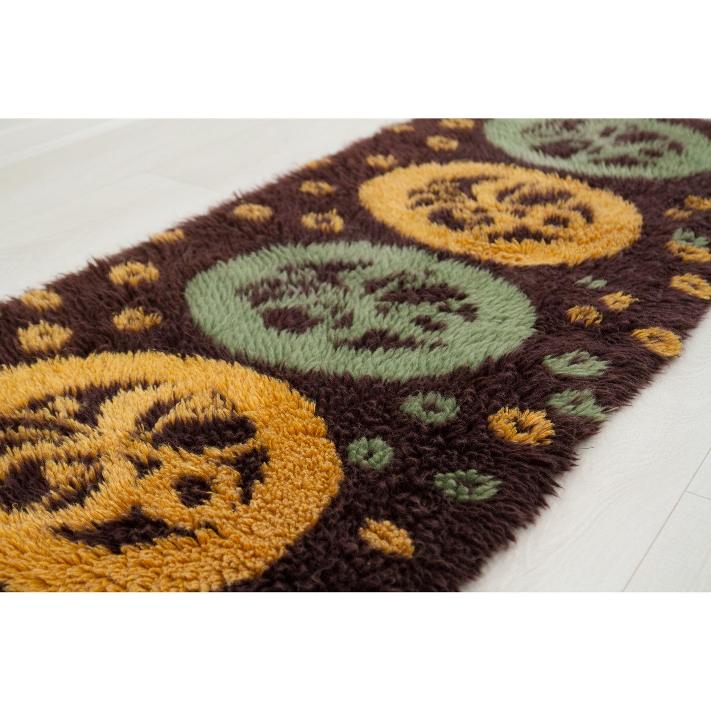 A close-up low angle shot peering over the delightfully long, incredibly plush cotton-blend yarns of the vintage Hungarian latch hook masterpiece.