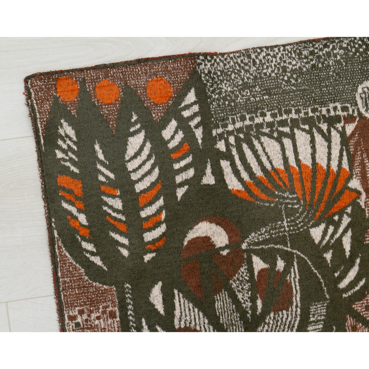 Extreme macro photograph of the vintage tapestry fabric. Captures the incredibly fine design details and vivid pop-art orange accents contrasting against the soft, short cotton-blend pile.