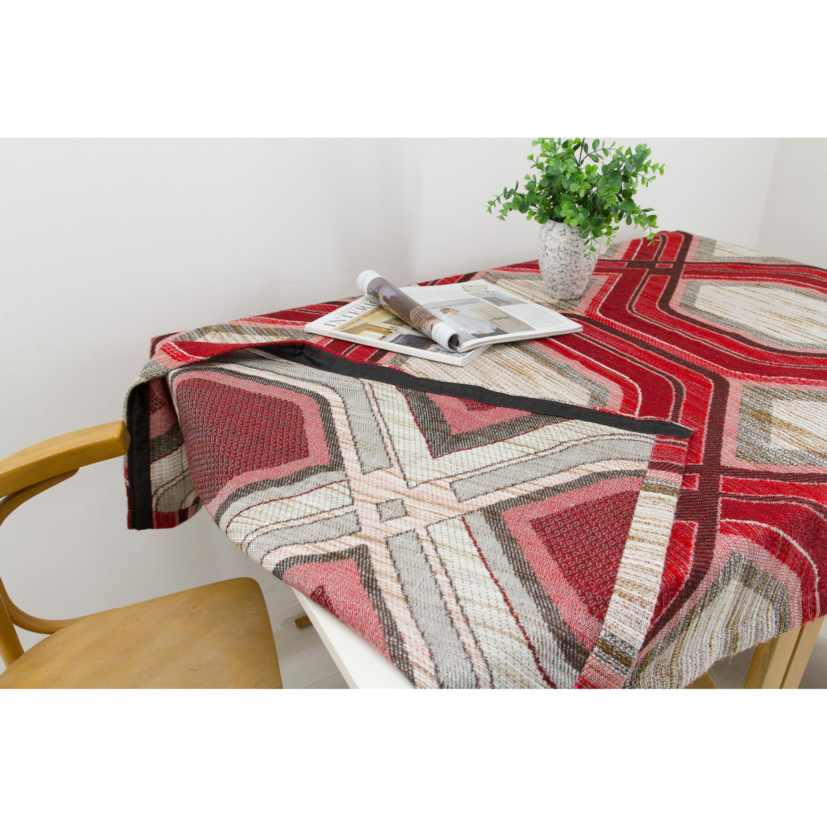Corner of a table covered with vintage geometric fabric showing how nicely it drapes