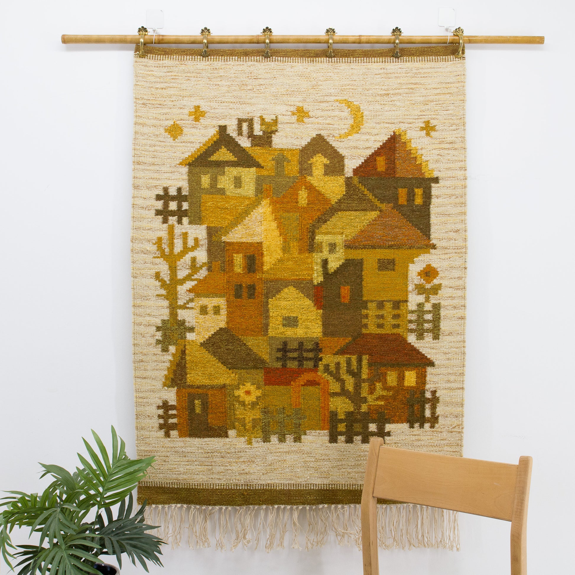Closer look at the warm, golden vintage cottagecore aesthetic tapestry styled neatly on a bamboo display rod using standard curtain clips.