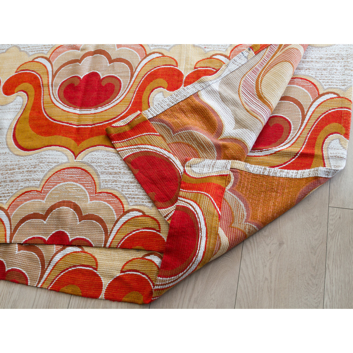 Vintage curtain fabric folded on a wooden floor, great textile for sewing and craft projects