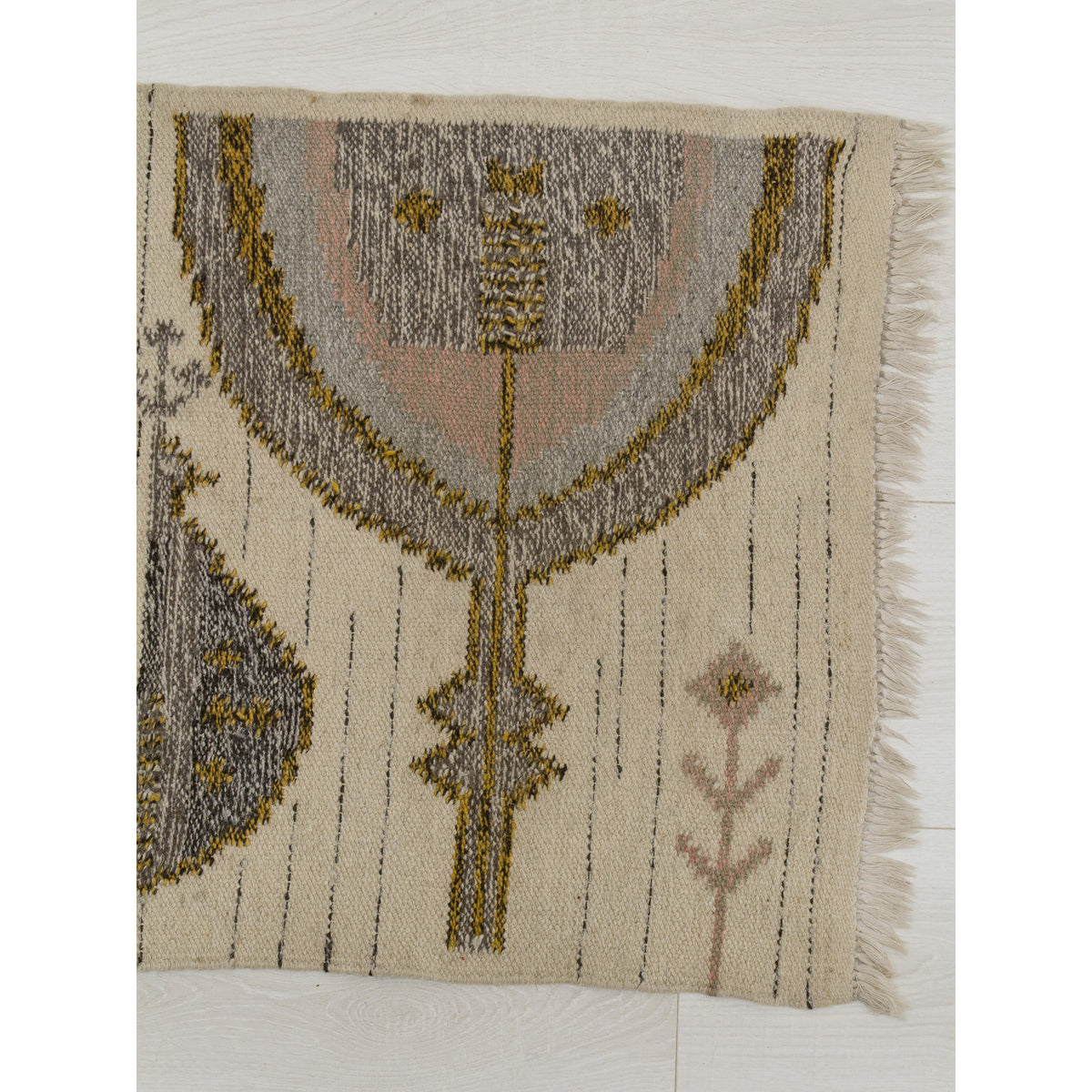 Detailed view of the large abstract tree of life motif of the wall hanging. The pattern features concentric curves in soft grey and blush pink, outlined in mustard yellow, typical of the organic modern aesthetic of the era.