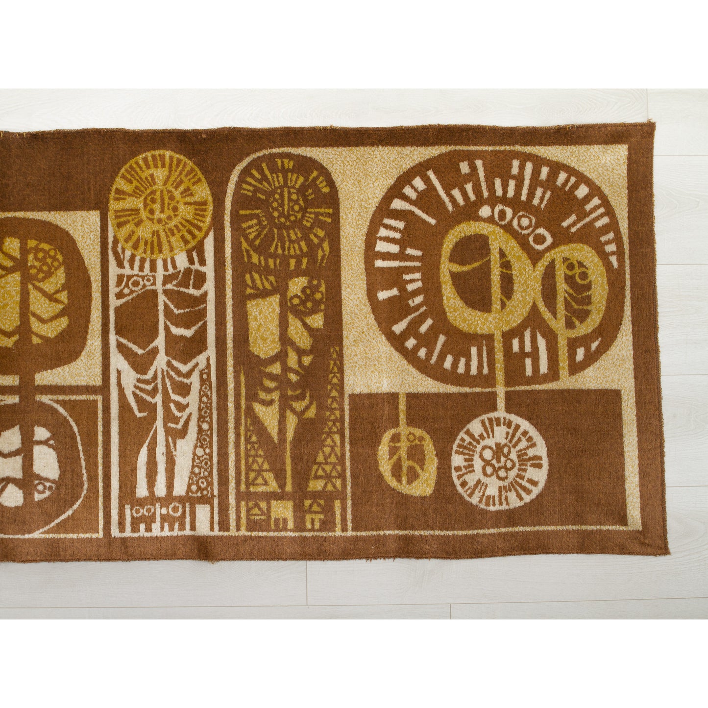Close-up of the tapestry's right section showing round shapes resembling of trees and two sleek, vertical shapes that reminds of oversized flowers. Rich chocolate brown background with warm caramel and beige woven accents. Authentic 1960s graphic design.