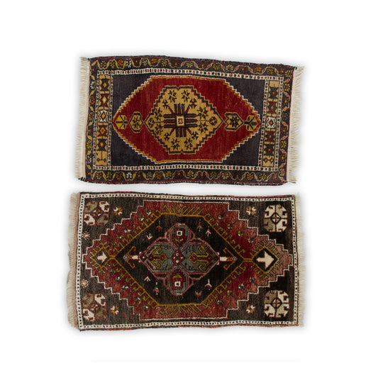 Set of two small vintage Turkish yastik rugs, one red with a gold medallion and one dark brown, shown from above