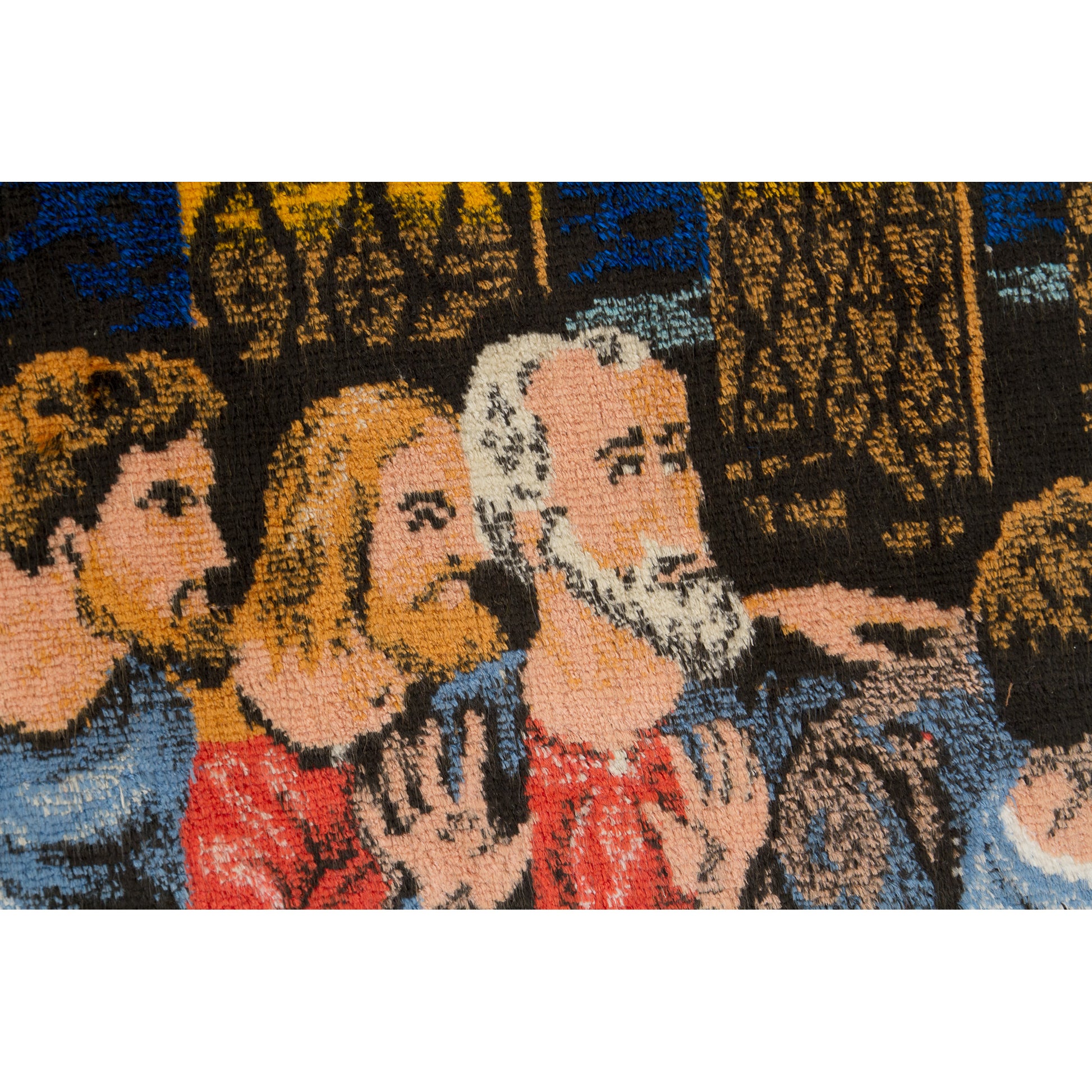 Extreme close-up of the tapestry material showcasing how beautifully the colorful velvet-like piles depict the detailed, emotional faces of the historic biblical men.